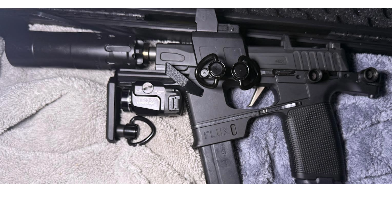 Black rifle on a textured surface